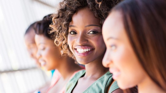 Group of happy African American students on a HBCU campus tour close-up.