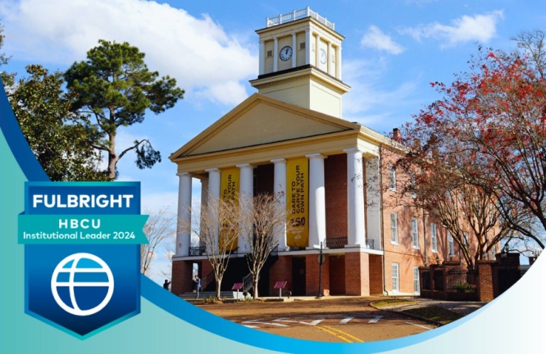 A historic campus building at a 2024 Fulbright HBCU Institutional Leader, with a clear blue sky and trees surrounding the structure.