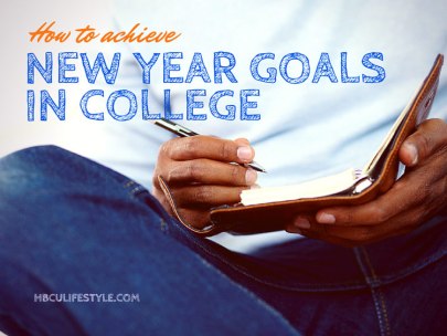 Hands of a young African American male student writing his New Year goals in a notepad.