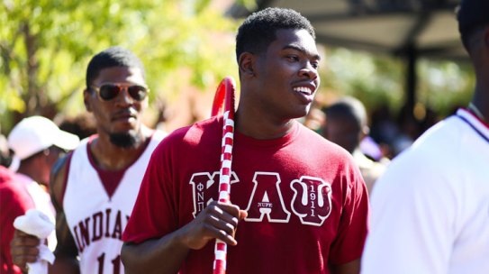 Black Greeks: A smiling member of Kappa Alpha Psi Fraternity strolls with his cane on the campus of Jackson State University during 2016 Pep Rally and yard Fest event.