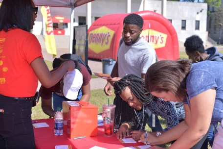 Students participate in the Denny's HFE College Tour sign-up booth