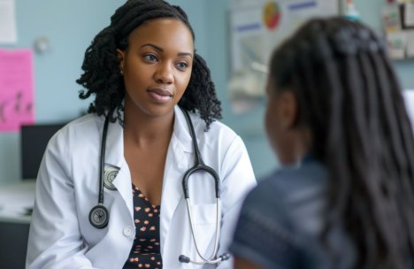 A healthcare professional at an HBCU Student Health Service center consults with a student.