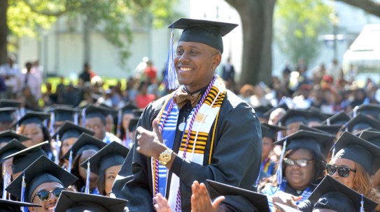 HBCU vs PWI Employment Debate: A graduate at 2016 Dillard University Commencement is recognized during the ceremony.