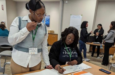 Participants engaging in brainstorming at the Hackathon for Social Change event.