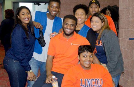 Students from Lincoln University, P.A., smiling and posing together at a campus event, showcasing university spirit in their attire.