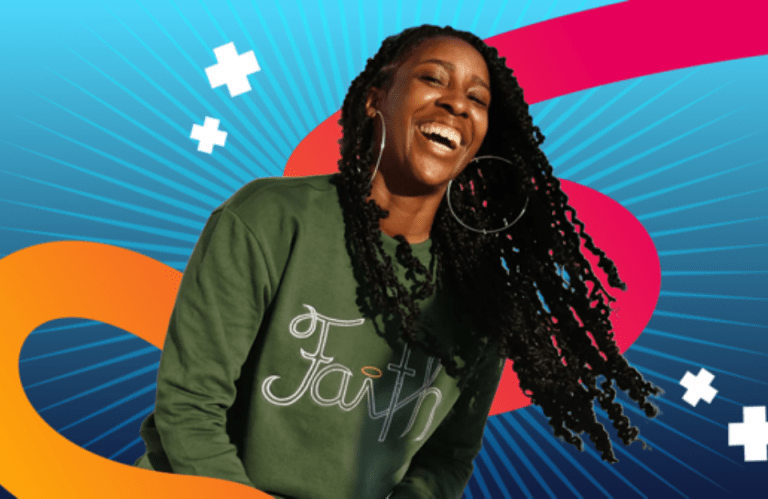 Hope Jefferson smiling in a 'Faith' sweatshirt from her clothing line, set against a vibrant background of blue and orange swooshes.