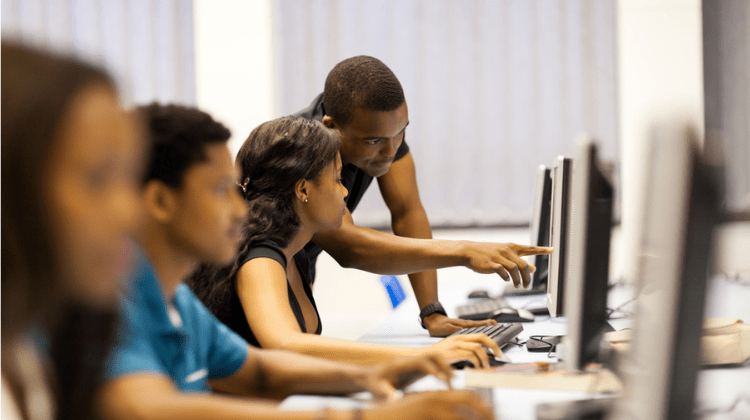 African American students in computer lab researching scholarships.