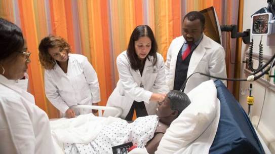 HBCU nursing programs students check a patient in class simulation.